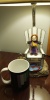 Eleven's just chillin' A felt doll of the protagonist of Dragon Quest 11, sitting on the beach chair decoration of a table lamp.